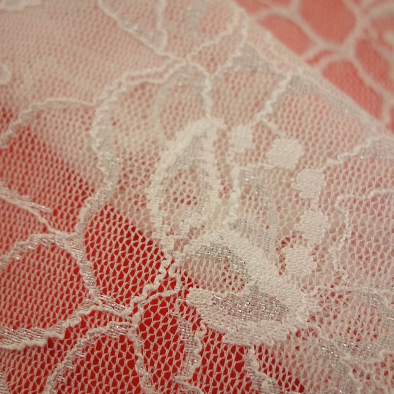 white and silver lace fabric